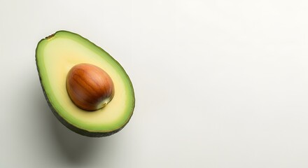 Fresh Ripe Avocado Half with Pit on Clean White Background perfect for recipe blogs, health articles, diet plans, food packaging,