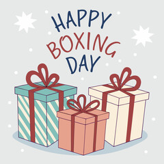 Illustration showing three wrapped gifts with ribbons and happy boxing day text with stars above it all