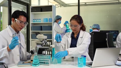 Scientists conducting research in a biotechnology lab, using pipettes and test tubes for medical and chemical experiments. - Powered by Adobe
