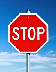 Obraz premium A classic red octagonal sign, white border, against a clear blue sky