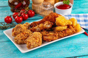 Golden crispy fried chicken mix - wings, drumsticks, nuggets and strips
