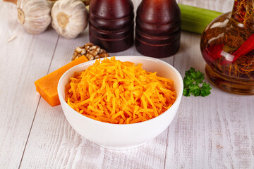 Yellow shredded cheddar cheese in the bowl