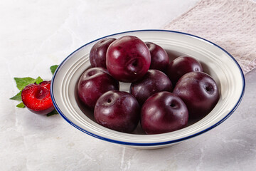 Raw ripe purple plum heap