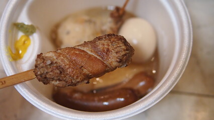A steaming pot of oden with assorted ingredients like daikon, fish cakes, and skewers