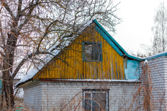 A yellow house with a blue roof