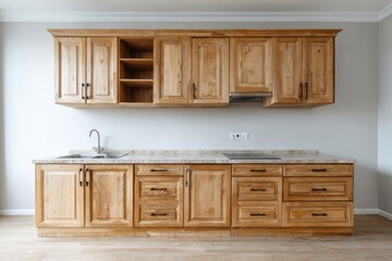 Fototapeta premium Clean kitchen with natural wood cabinets and stainless steel sink.