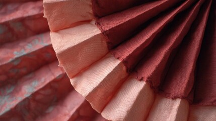 Close-up of a fabric with a ruffled texture. the fabric appears to be made of a soft, silky material and has a peach-colored hue.