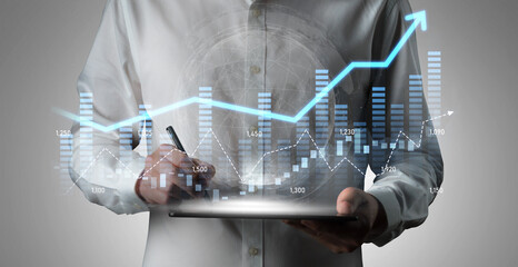 A business professional engages with digital financial data, analyzing trends and growth patterns on a tablet in a sleek modern office, showcasing expertise in analytics. Scalp