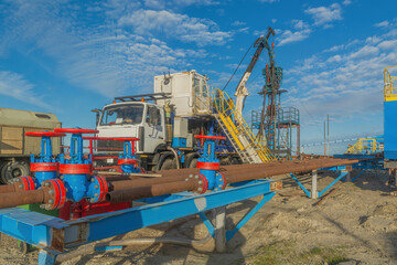 The Northern gas field. Summer. Installation for lowering a flexible pipe into a well. Equipment for testing and development of a gas well