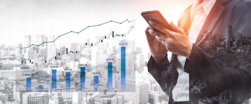 A business professional checks data on a smartphone while standing against a modern city skyline, showcasing digital graphs that represent financial market growth trends. Scalp
