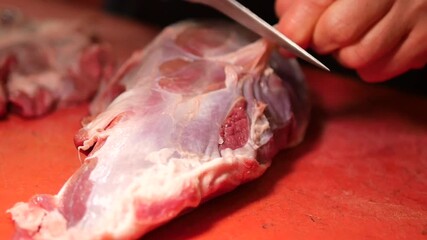 Preparing fresh meat at a local market stall