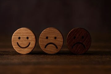 Wooden Emotion Faces Showing Happy, Sad, and Distressed