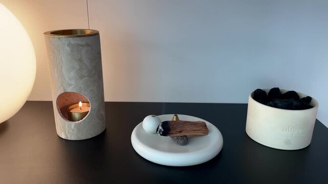 Burning incense wood for relaxation &ndash; aromatic smoke rising in cozy home interior with warm calm atmosphere
