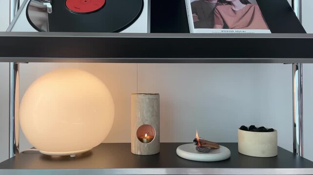 Burning incense wood for relaxation &ndash; aromatic smoke rising in cozy home interior with warm calm atmosphere
