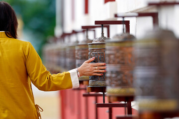 Buddhist temple. Woman turning the prayer wheels.  La Boulaye. France.