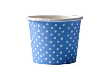 A small paper cup with a blue polka-dot pattern, standing isolated against a black background