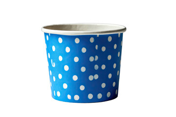 Close-up of a blue paper cup with white polka dots against a stark, black background