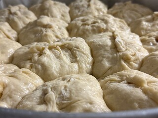 Close-up of raw pies placed on a baking sheet. Homemade cooking.