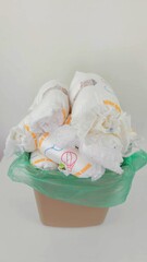 Diapers Waste: Overflowing trash bin filled with used baby diapers