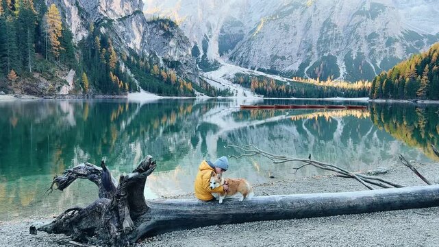 Enjoying a peaceful moment by Lago di Bries with a dog amid stunning mountain views in Italy