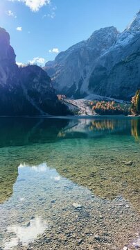 Explore the stunning autumn colors of Lago di Bries in Italy with wonderful reflections and serene views