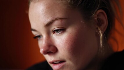 A woman reflects deeply in soft light, showcasing her emotions. Intimate close-ups reveal her expressions, highlighting an introspective moment.