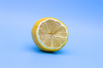 Half-Dried yellow lemon on a blue background, close