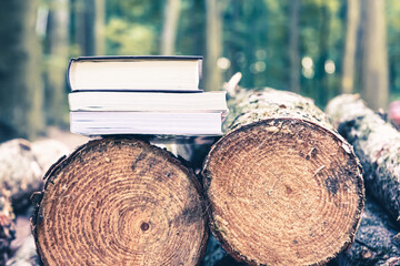 Paper books on fallen trees, the concept of the problem of forest conservation and tree felling for industrial paper production