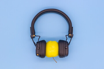 Yellow Apple in headphones listening to music, concept don't be a vegetable, listen to good quality music