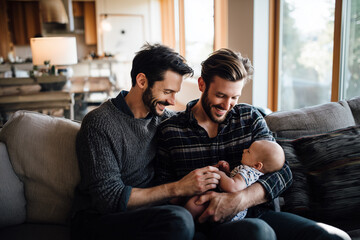 LGBTQ+ couple lovingly caring for their baby at home. Heartwarming representation of modern family life filled with tenderness, equality, and emotional connection.