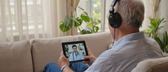Online Consultation: An elderly man engaged in a video consultation with a medical expert, highlighting the modern accessibility of healthcare through technology.