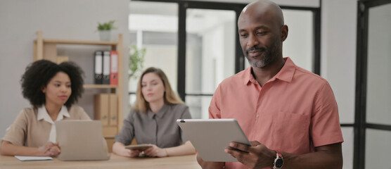 Business Professionals in Office: The scene shows diverse business people working together in a modern office environment. With each individual engrossed in their respective tasks, a sense of focus.