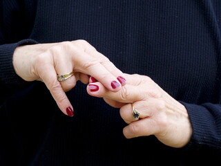A pair of hands signing the consonant letter 'F' in British Sign Language.BSL.Communication.Hearing Impaired.