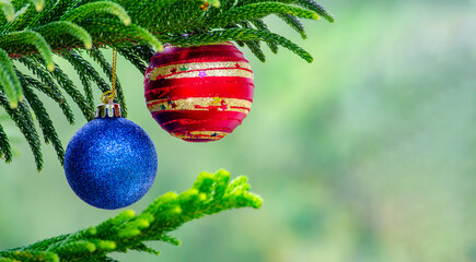 Golden Christmas balls with blur Christmas background with customizable space for text.