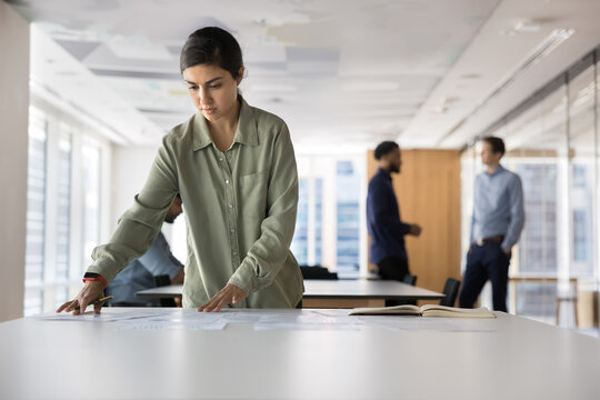 Busy millennial woman executive thinking on statistic information at workplace