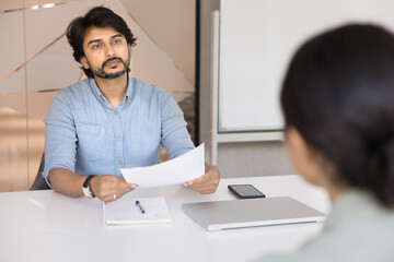 Serious confident middle aged male hr manager interviewing female applicant