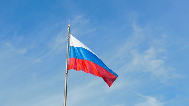 A huge Russian flag on the border with Lithuania. A tricologist on the flagpole. A real flag.