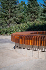 Round benches with flower beds in the city park.