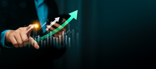 Business growth and financial success concept with businessman hand pointing at rising arrow and bar chart, strategy planning, investment, market analysis, economic development, performance, revenue