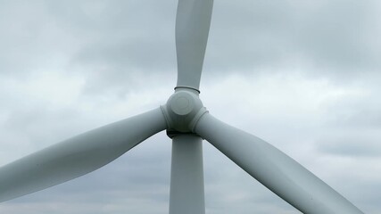 Close-up of the wind turbine rotor against a wide low mountain landscape in the Sauerland region - Powered by Adobe
