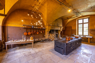 Fototapeta premium Traditional Chateau de Commarin kitchen with historical iron stove