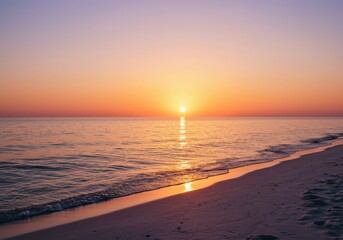 Obraz premium Brilliant setting sun reflects intensely across calm ocean water bordering a tranquil sandy shore