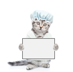 Cute kitten with shower cap on it head wearing bathrobe standing on hind legs and holding blank white board. Empty space for text. Isolated on white background