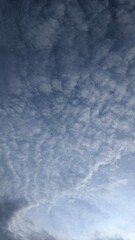 Fototapeta premium Cirrocumulus Clouds Patterned Across a Serene Blue Sky During Daytime