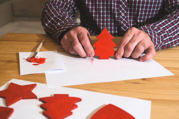 Man painting wooden christmas tree diy decoration