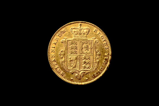 Queen Victoria 1819-1901 gold half sovereign coin dated 1853 reverse back shield cut out and isolated on a black background, antique coinage collecting stock photo