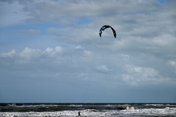 Kitesurfing at italian beach. Some kitesurfers at Torre del Lago beach, tuscany, italy. Some are junping out of the water. Mediterraenean Sea.