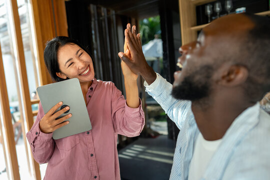 Successful couple working together, celebrating shared achievements. Positive collaboration