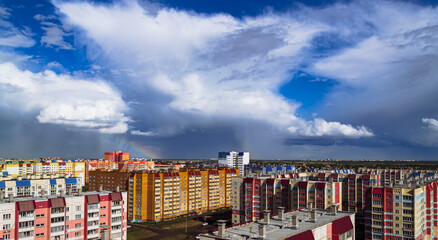 Amazing cloudy landscape above multi-colored residential buildings