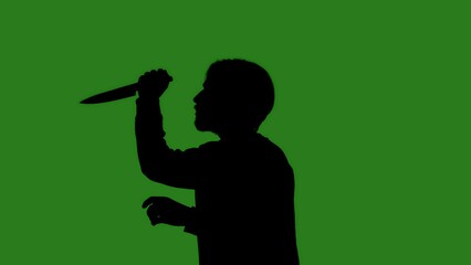 Black isolated silhouette of a man with a large knife on a green chroma key background. Minimalist contrast and modern visual composition, mockup.